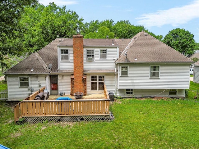 6305 N Bales Ave, Gladstone, MO 64119 - rear view of house with a deck, a lawn, a chimney, a fire pit, and a shingled roof
