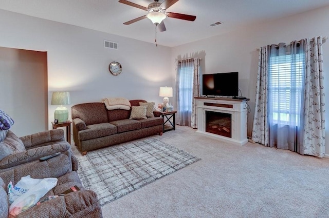 8025 SE 6th Ter, Blue Springs, MO 64014 - carpeted living room featuring ceiling fan and a fireplace