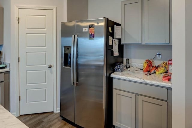 8025 SE 6th Ter, Blue Springs, MO 64014 - kitchen featuring stainless steel refrigerator with ice dispenser, wood finished floors, gray cabinetry, and light stone counters