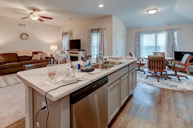 8025 SE 6th Ter, Blue Springs, MO 64014 - kitchen featuring dishwasher, open floor plan, wood finished floors, an island with sink, and a ceiling fan