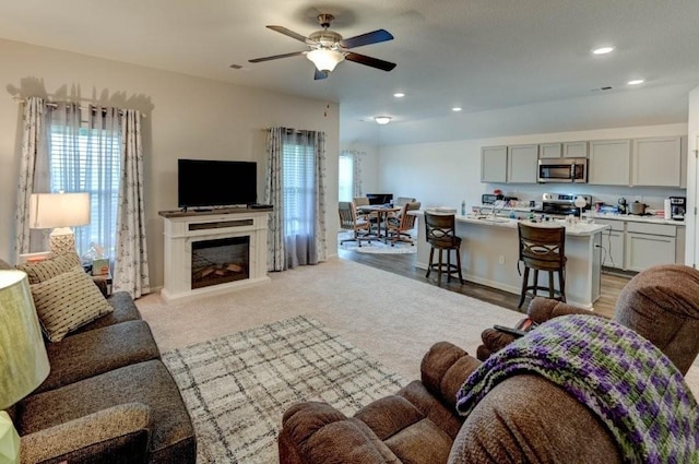 8025 SE 6th Ter, Blue Springs, MO 64014 - living area featuring a ceiling fan, a glass covered fireplace, and recessed lighting