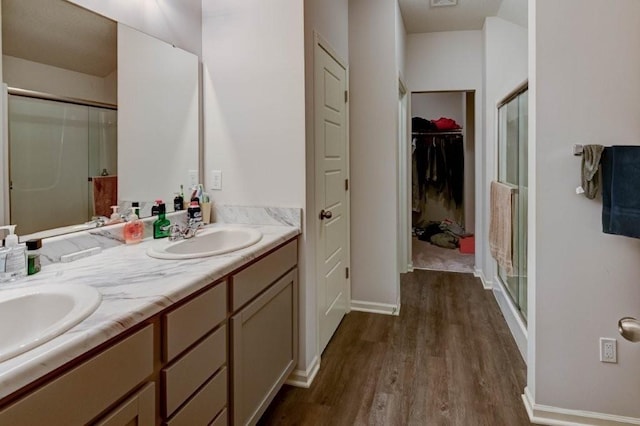 8025 SE 6th Ter, Blue Springs, MO 64014 - full bath with wood finished floors, a shower stall, double vanity, and a walk in closet