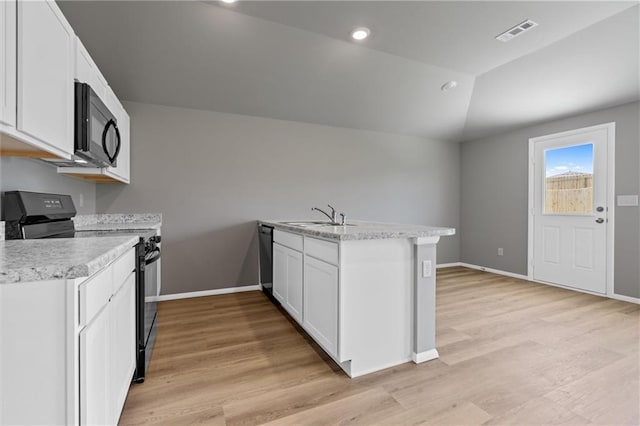 37770 W 207th Ter, Edgerton, KS 66021 - kitchen with black appliances, a peninsula, light countertops, light wood finished floors, and vaulted ceiling