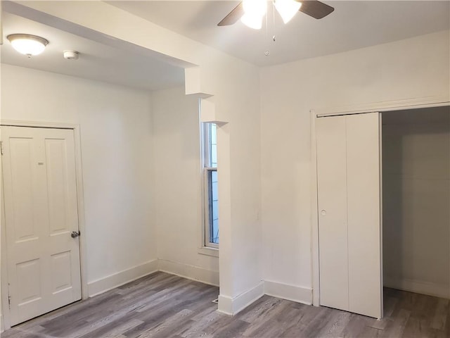 605 Hall St, Saint Joseph, MO 64501 - unfurnished bedroom featuring wood finished floors, a closet, and a ceiling fan