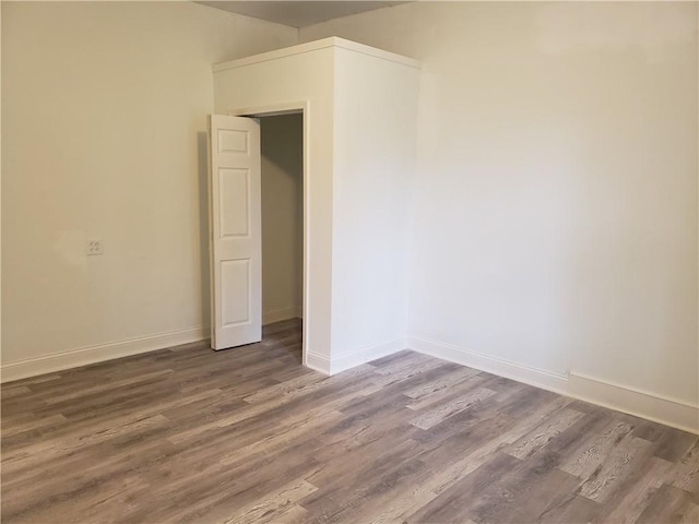 605 Hall St, Saint Joseph, MO 64501 - unfurnished bedroom featuring wood finished floors and baseboards