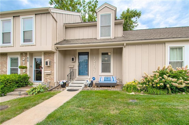12131 W 82nd Ter, Lenexa, KS 66215 - view of property featuring board and batten siding and a front lawn