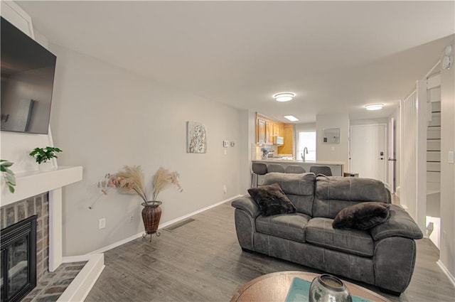 12131 W 82nd Ter, Lenexa, KS 66215 - living room featuring wood finished floors and a glass covered fireplace