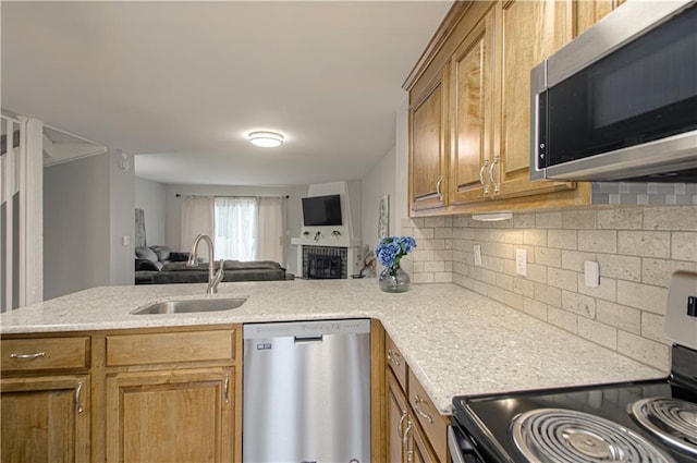 12131 W 82nd Ter, Lenexa, KS 66215 - kitchen with stainless steel appliances, open floor plan, tasteful backsplash, a peninsula, and brown cabinets