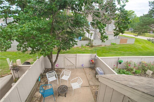 12131 W 82nd Ter, Lenexa, KS 66215 - fenced backyard featuring a gate, a patio, and an outdoor fire pit