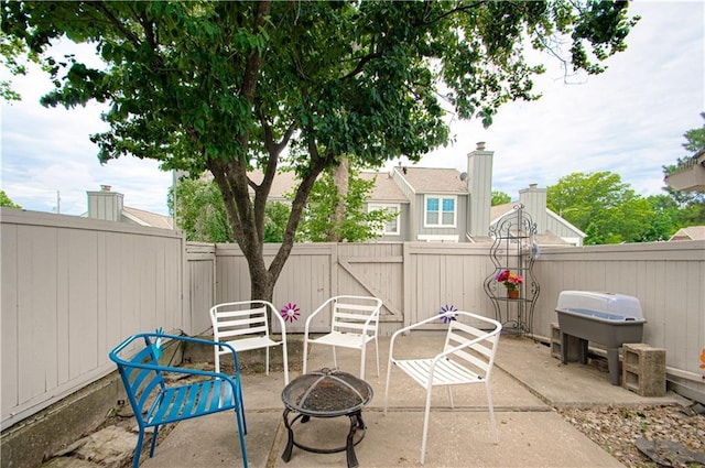 12131 W 82nd Ter, Lenexa, KS 66215 - fenced backyard with a fire pit, a patio, and area for grilling