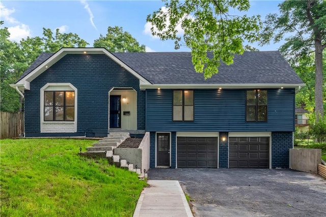 10312 W 48th Ter, Shawnee, KS 66203 - view of front of home featuring an attached garage, asphalt driveway, and roof with shingles
