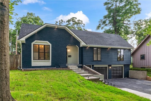 10312 W 48th Ter, Shawnee, KS 66203 - view of front of property featuring a garage, asphalt driveway, brick siding, and roof with shingles