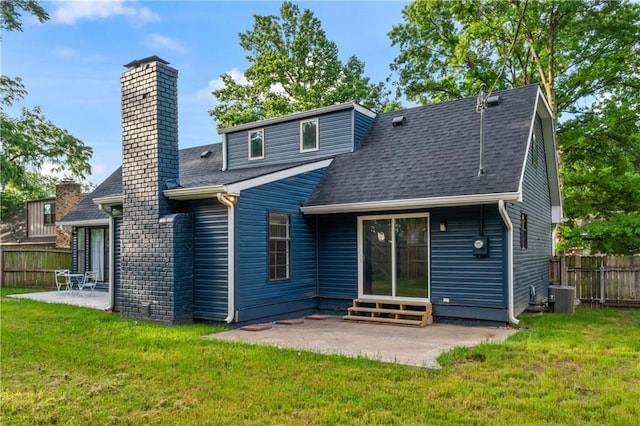 10312 W 48th Ter, Shawnee, KS 66203 - back of property featuring entry steps, a patio, a shingled roof, and a chimney
