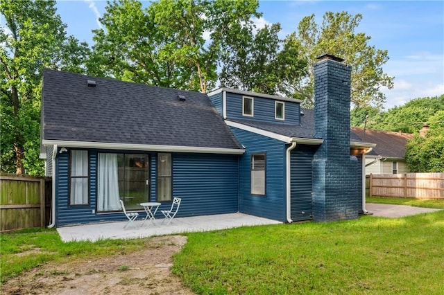 10312 W 48th Ter, Shawnee, KS 66203 - rear view of house featuring a patio area, roof with shingles, and a chimney