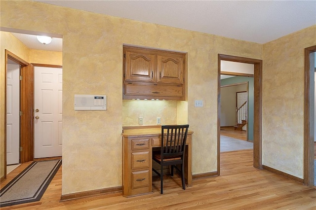 18807 E 34th St, Independence, MO 64057 - kitchen featuring light wood finished floors, a desk, brown cabinetry, and light countertops