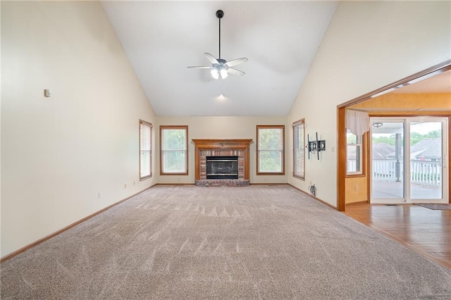18807 E 34th St, Independence, MO 64057 - unfurnished living room featuring carpet flooring, high vaulted ceiling, ceiling fan, and a brick fireplace
