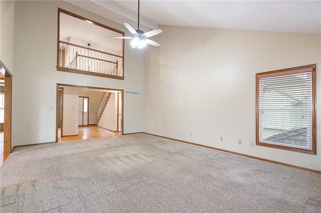 18807 E 34th St, Independence, MO 64057 - unfurnished living room featuring light carpet, high vaulted ceiling, ceiling fan, and stairs