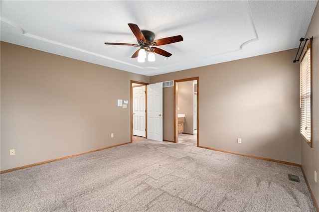 18807 E 34th St, Independence, MO 64057 - unfurnished bedroom featuring carpet floors, ensuite bathroom, and ceiling fan