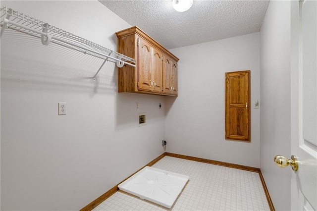 18807 E 34th St, Independence, MO 64057 - laundry room featuring hookup for an electric dryer, cabinet space, hookup for a washing machine, and a textured ceiling