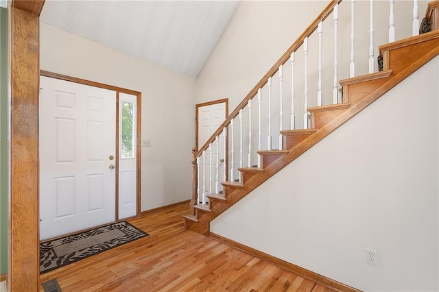 18807 E 34th St, Independence, MO 64057 - foyer entrance with wood finished floors, high vaulted ceiling, and stairs