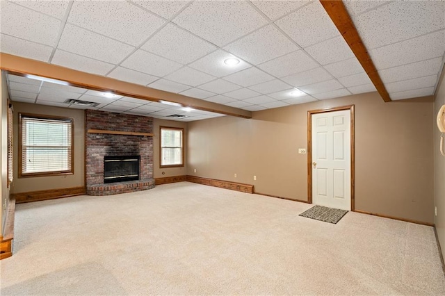 18807 E 34th St, Independence, MO 64057 - unfurnished living room with carpet, a fireplace, and a drop ceiling