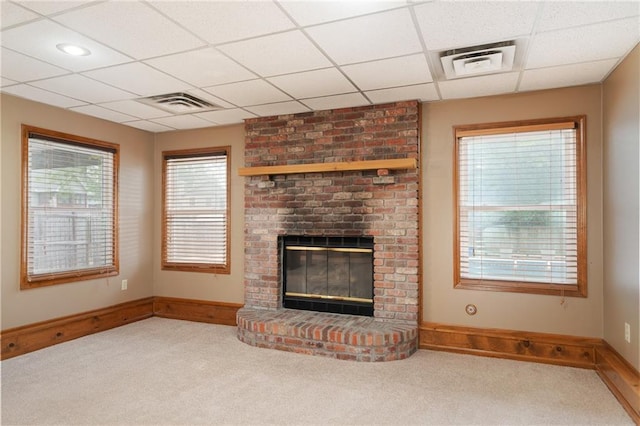 18807 E 34th St, Independence, MO 64057 - unfurnished living room featuring carpet flooring, a fireplace, and a paneled ceiling