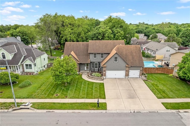 18807 E 34th St, Independence, MO 64057 - view of front of house featuring a residential view, concrete driveway, and a garage