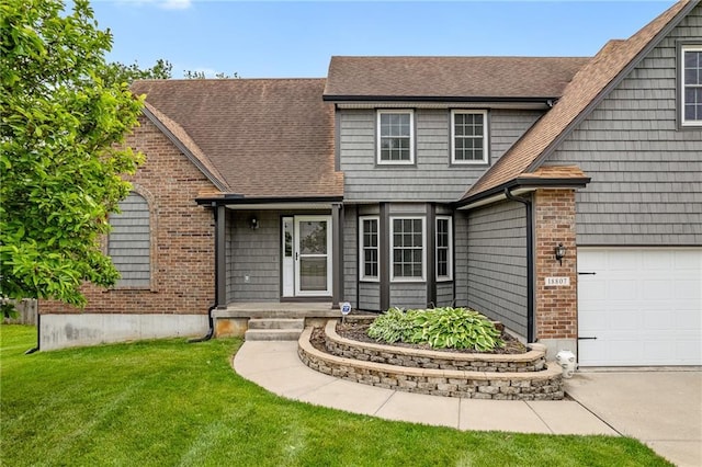 18807 E 34th St, Independence, MO 64057 - view of front facade featuring a shingled roof, a front yard, brick siding, and driveway