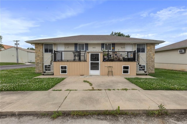 301-A N 3rd St, Odessa, MO 64076 - view of front of property with stairway, stone siding, and a front lawn