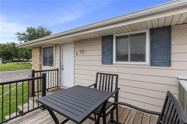 301-A N 3rd St, Odessa, MO 64076 - wooden deck featuring outdoor dining area