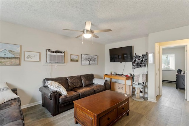 301-A N 3rd St, Odessa, MO 64076 - living area with an AC wall unit, ceiling fan, light wood finished floors, and a textured ceiling