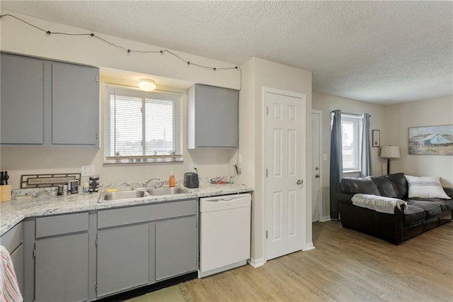 301-A N 3rd St, Odessa, MO 64076 - kitchen featuring dishwasher, gray cabinets, a textured ceiling, light wood finished floors, and light countertops