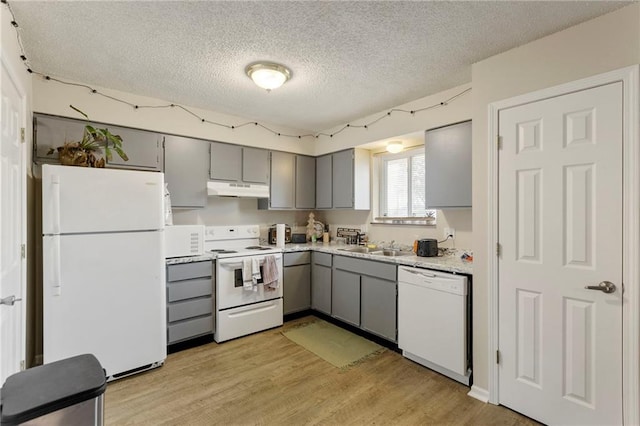 301-A N 3rd St, Odessa, MO 64076 - kitchen featuring white appliances, gray cabinets, under cabinet range hood, a textured ceiling, and light wood-style flooring