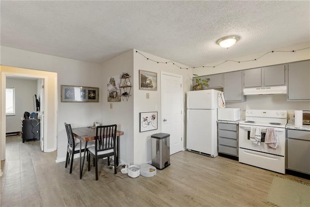 301-A N 3rd St, Odessa, MO 64076 - kitchen featuring white appliances, under cabinet range hood, gray cabinets, light wood-style floors, and a textured ceiling
