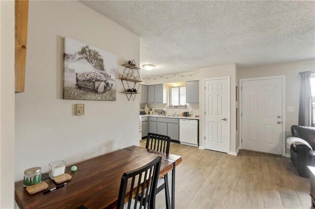 301-A N 3rd St, Odessa, MO 64076 - dining area featuring a textured ceiling and light wood-style floors