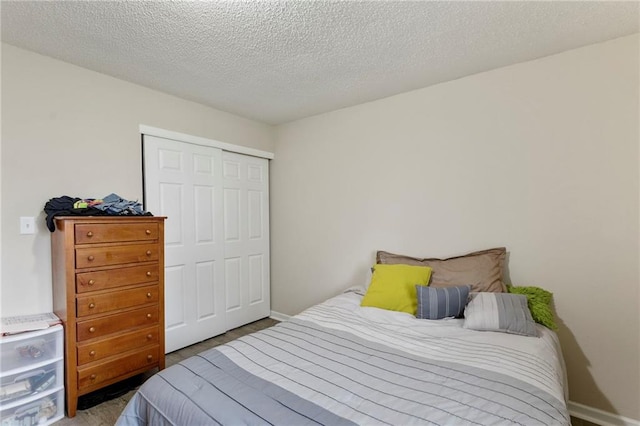 301-A N 3rd St, Odessa, MO 64076 - bedroom with a closet and a textured ceiling