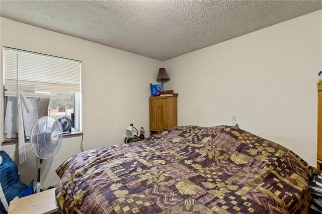 301-A N 3rd St, Odessa, MO 64076 - bedroom featuring a textured ceiling