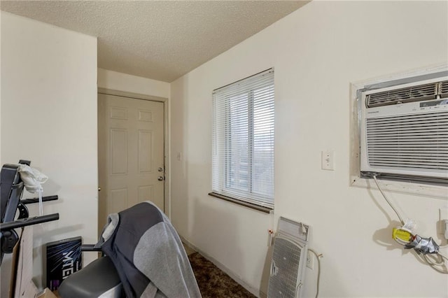 301-A N 3rd St, Odessa, MO 64076 - home office with a textured ceiling, a wall mounted air conditioner, and heating unit