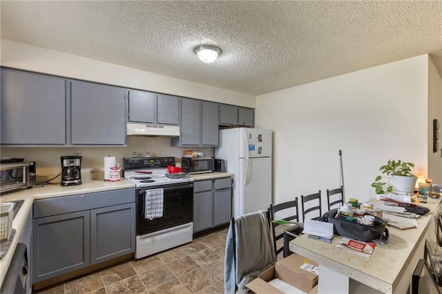 301-A N 3rd St, Odessa, MO 64076 - kitchen with electric range, under cabinet range hood, freestanding refrigerator, gray cabinets, and a textured ceiling