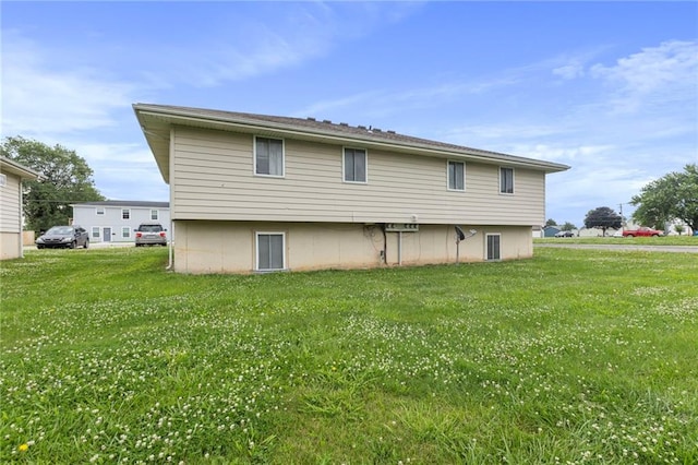 301-A N 3rd St, Odessa, MO 64076 - rear view of house featuring a yard
