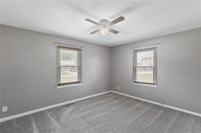 801 NE 67th Ter, Gladstone, MO 64118 - unfurnished room featuring a ceiling fan, carpet floors, and a textured ceiling