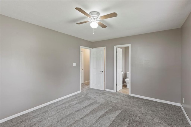 801 NE 67th Ter, Gladstone, MO 64118 - unfurnished bedroom featuring carpet, connected bathroom, and a ceiling fan