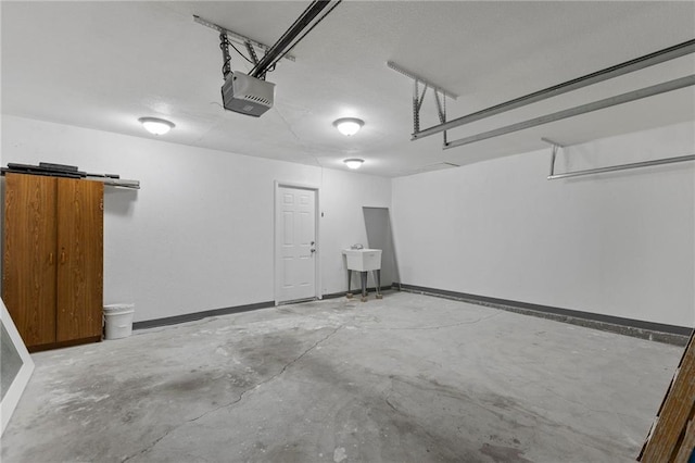 801 NE 67th Ter, Gladstone, MO 64118 - garage featuring a garage door opener and a sink