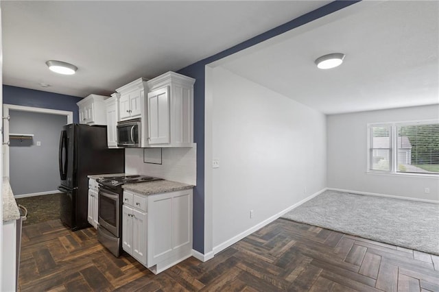 801 NE 67th Ter, Gladstone, MO 64118 - kitchen with stainless steel appliances, white cabinetry, light stone countertops, and open floor plan
