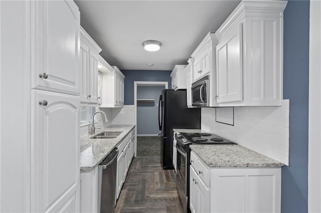 801 NE 67th Ter, Gladstone, MO 64118 - kitchen featuring stainless steel appliances, decorative backsplash, white cabinets, and light stone counters