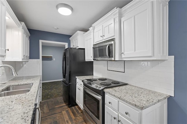 801 NE 67th Ter, Gladstone, MO 64118 - kitchen featuring appliances with stainless steel finishes, tasteful backsplash, white cabinetry, and light stone countertops