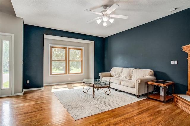 18300 Oak St, Gardner, KS 66030 - living room with wood finished floors, ceiling fan, and a textured ceiling