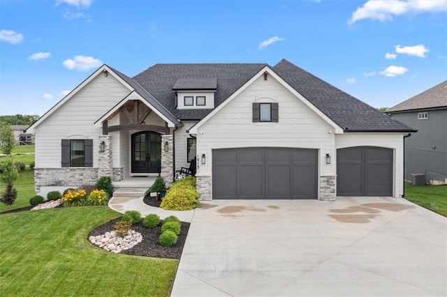1013 Old Hickory Rd, Greenwood, MO 64034 - view of front of house featuring french doors, stone siding, a front yard, concrete driveway, and roof with shingles