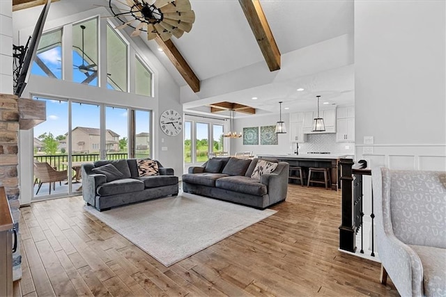 1013 Old Hickory Rd, Greenwood, MO 64034 - living room with light wood-style flooring, beamed ceiling, and high vaulted ceiling