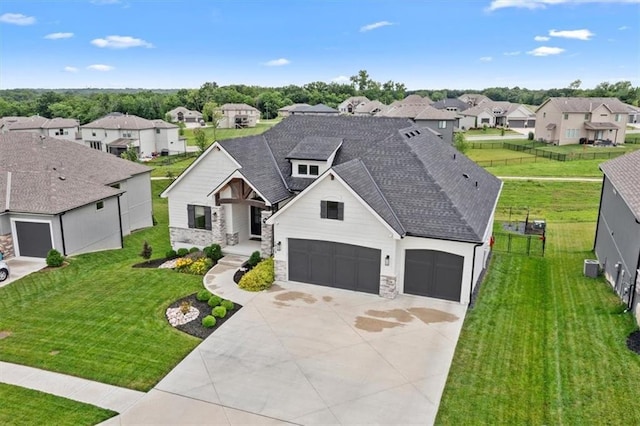 1013 Old Hickory Rd, Greenwood, MO 64034 - view of front facade with a residential view, stone siding, driveway, and a shingled roof